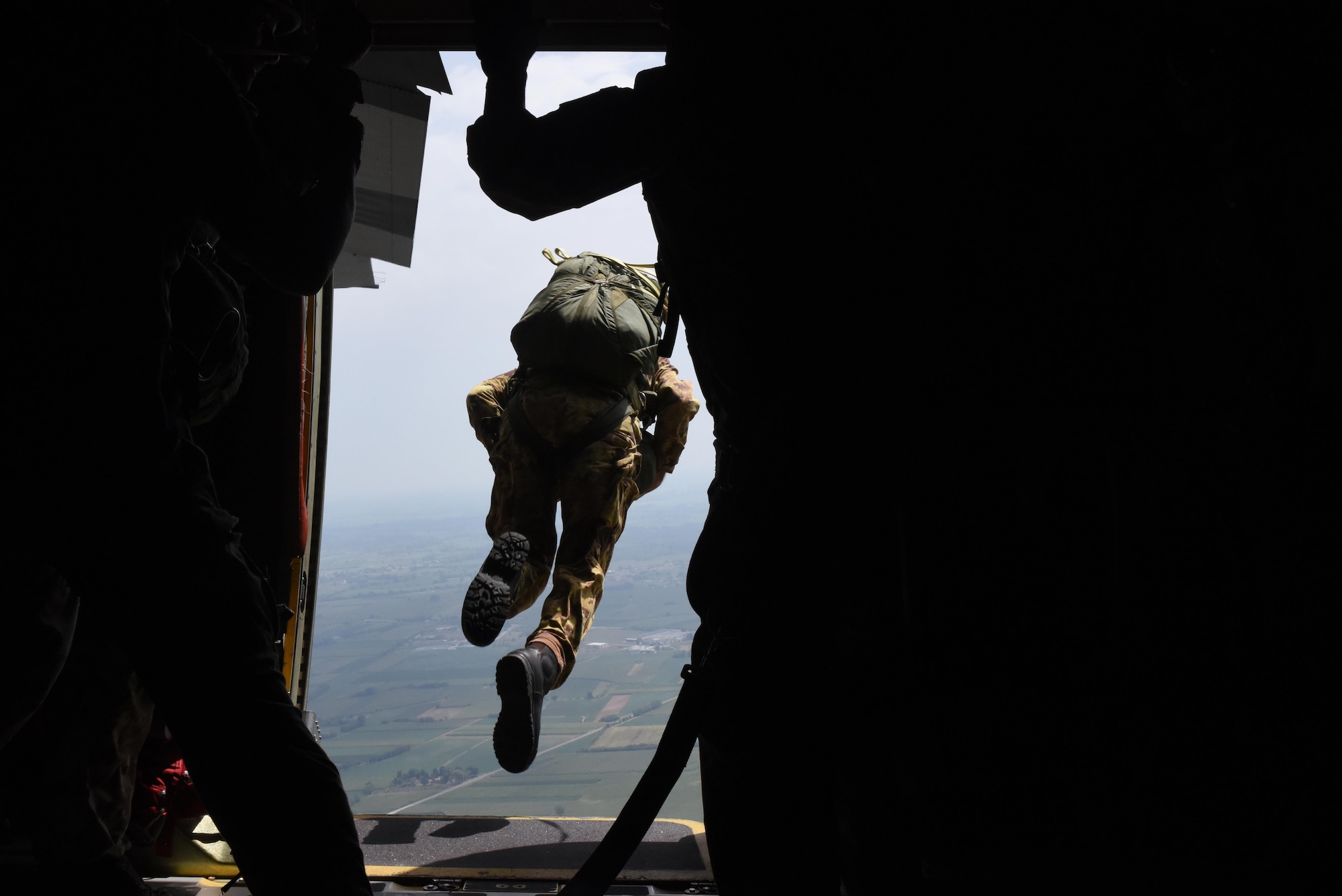 A member of the Italian armed forces performs a static-line jump from a 37th Airlift Squadron C-130J Super Hercules during exercise Ares Shadow, Aug. 10. This exercise marked the first time the 57th Rescue Squadron jumped with the Italian armed forces. (U.S. Air Force photo/Airman 1st Class Eli Chevalier)