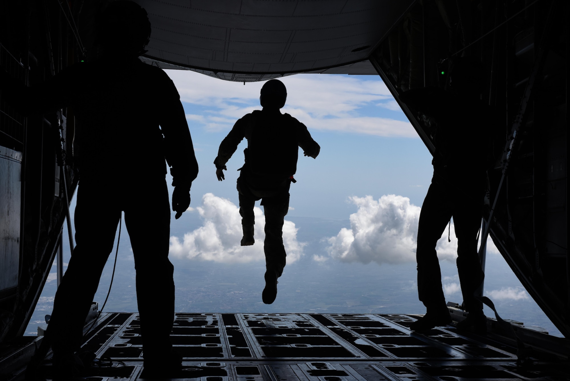 An Airman assigned to the 57th Rescue Squadron begins a freefall jump from a 37th Airlift Squadron C-130J Super Hercules during exercise Ares Shadow, Aug. 11. Ares Shadow is a 48th Fighter Wing-led personnel recovery exercise involving Airmen from across U.S. Air Forces in Europe, Air Force Special Operations Command, as well as members of the Italian armed forces. (U.S. Air Force photo/Airman 1st Class Eli Chevalier)