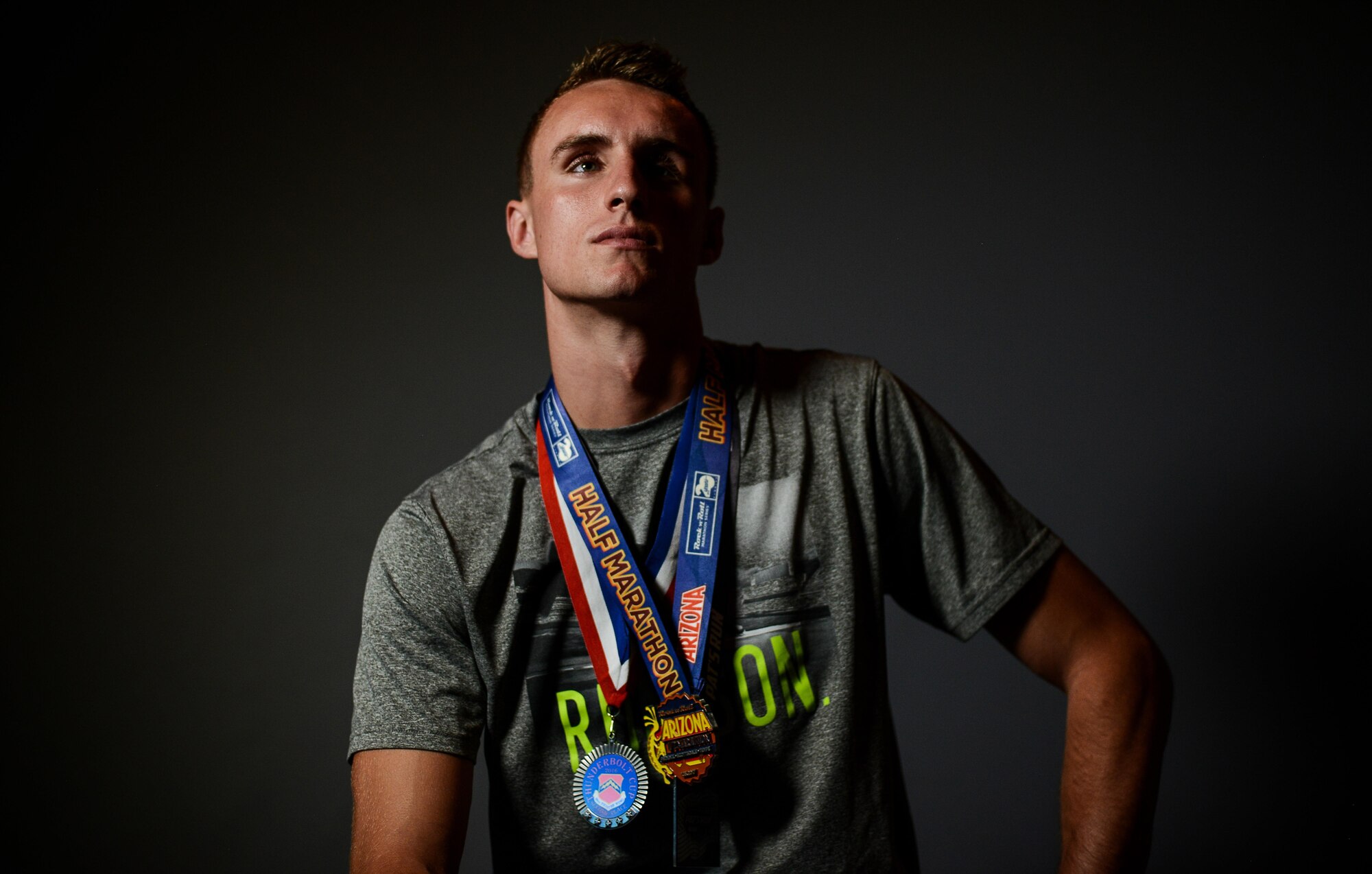 Airman 1st Class Wyatt Weaver, 56th Operations Support Squadron aircrew flight equipment journeyman, poses for a portrait at Luke Air Force Base, Ariz., July 28, 2017. Weaver competes in several different events both on and off base. To date, he has won 12 first place titles in base 5k races and half-marathons. (U.S. Air Force Photo/Airman 1st Class Alexander Cook)