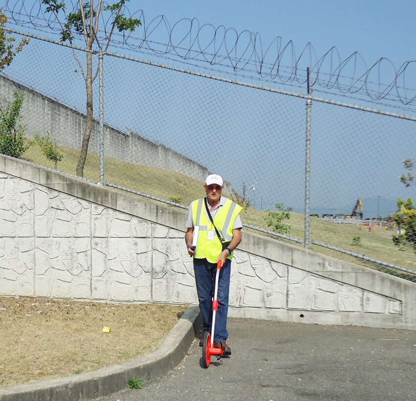 US Army Corps of Engineers Buffalo District engineer Robert Simmington measures a lot as part of a facility condition assessment on a federal property in South Korea in June 2017.