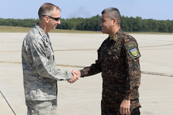 U.S. Air National Guard Col. James P. Ryan, the 157th Air Refueling Wing commander, shakes hands with Brig. Gen. Guillermo Adolfo Herrador Pena, the chief of the Salvadoran armed forces, on August 10, 2017 at Pease Air National Guard Base, N.H.