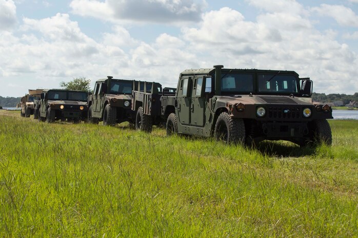 Sailors signal a landing craft to land on a beach to conduct lighterage during a maritime prepositioning force exercise at Blount Island, Fla., Aug. 13, 2017