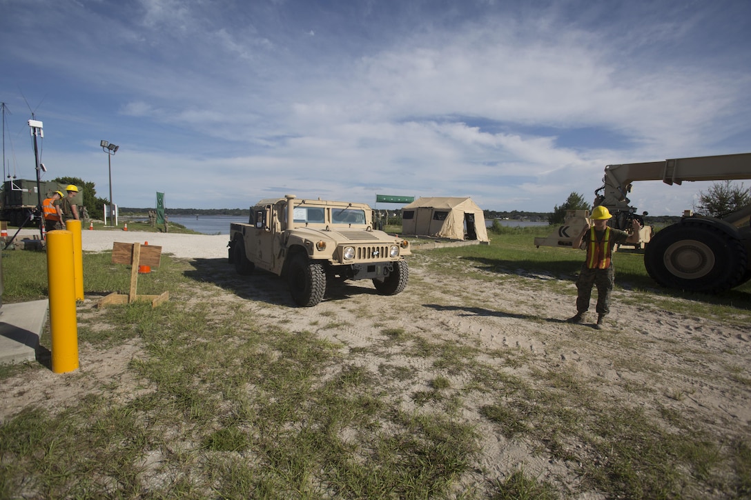 Marines drive a medium tactical vehicle replacement to a staging area during a maritime prepositioning force exercise at Blount Island, Fla., Aug. 10 - 11, 2017.