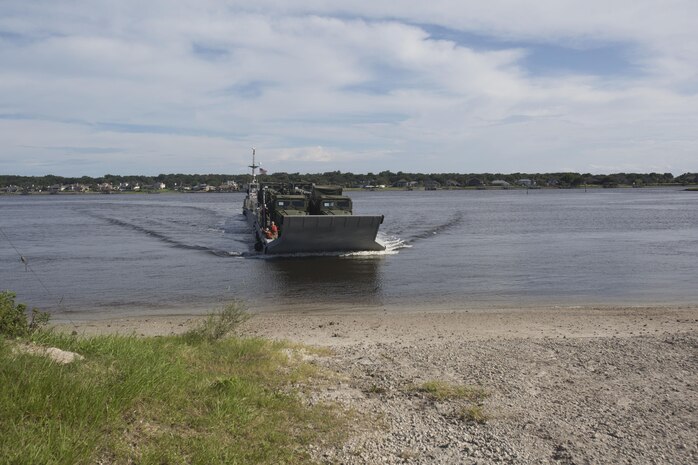 Marines drive a medium tactical vehicle replacement to a staging area during a maritime prepositioning force exercise at Blount Island, Fla., Aug. 10 - 11, 2017.