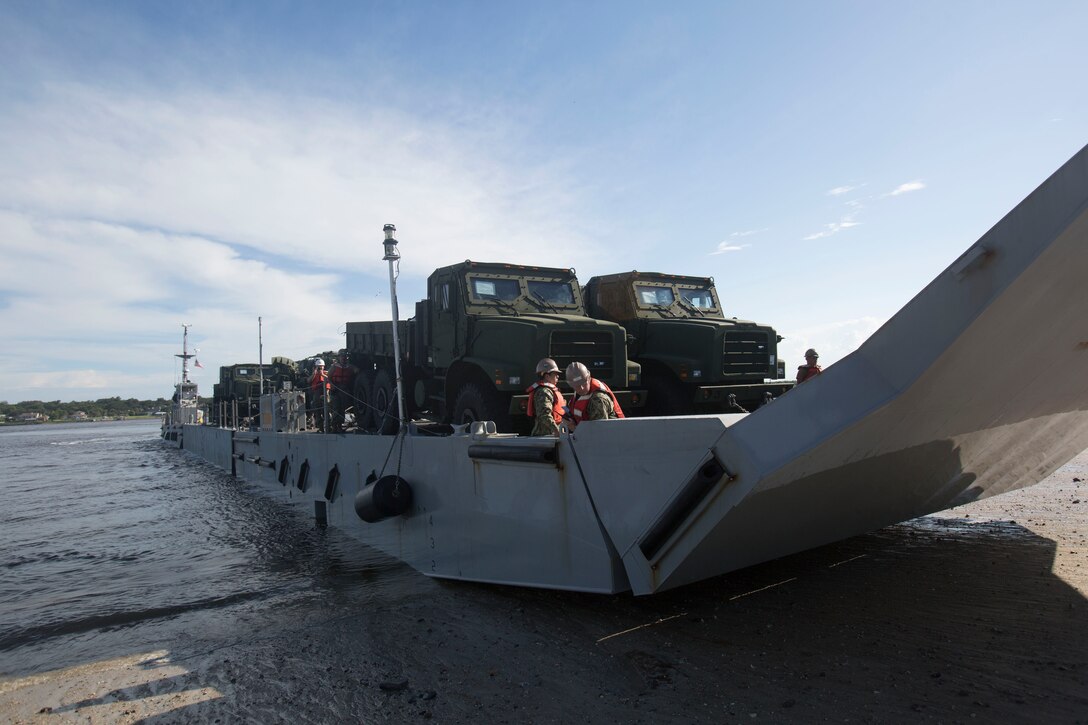 Marines drive a medium tactical vehicle replacement to a staging area during a maritime prepositioning force exercise at Blount Island, Fla., Aug. 10 - 11, 2017.