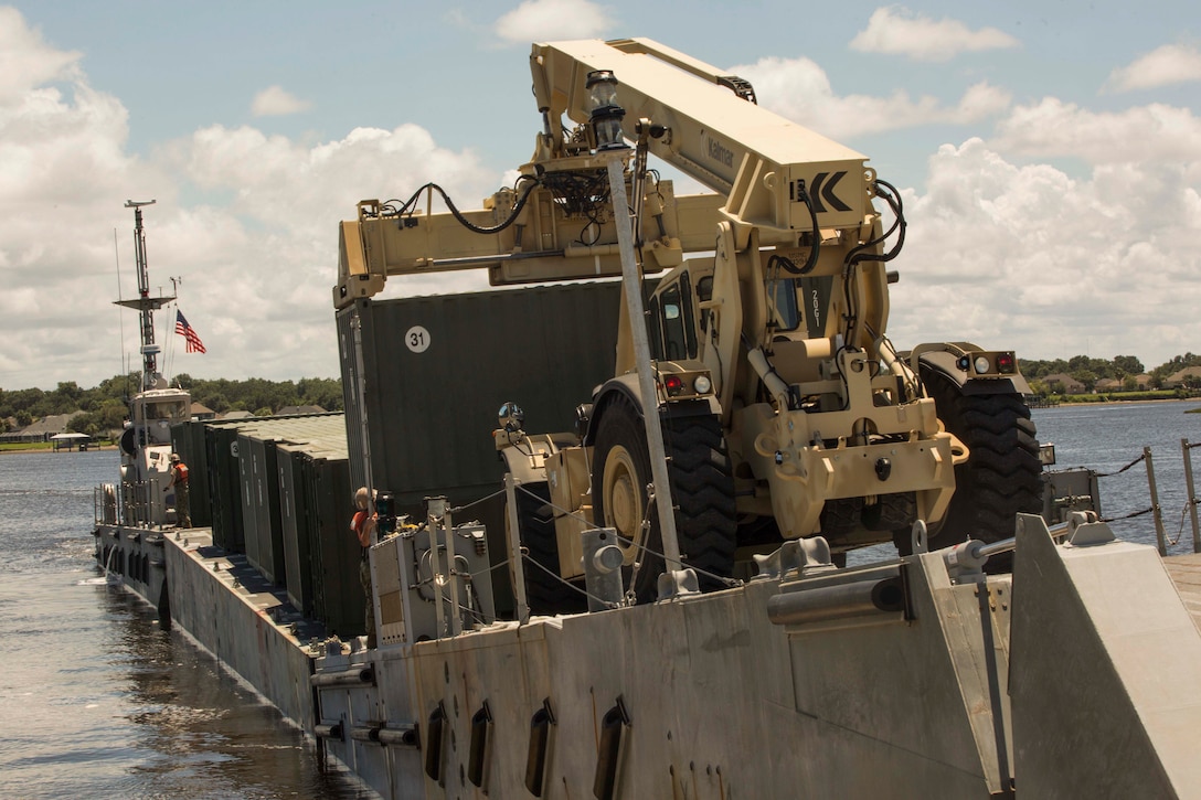 Sailors aboard a naval landing craft prepare to land and perform a lighterage during a marine prepositioning force exercise at Blount Island, Fla., Aug. 10 - 11, 2017.