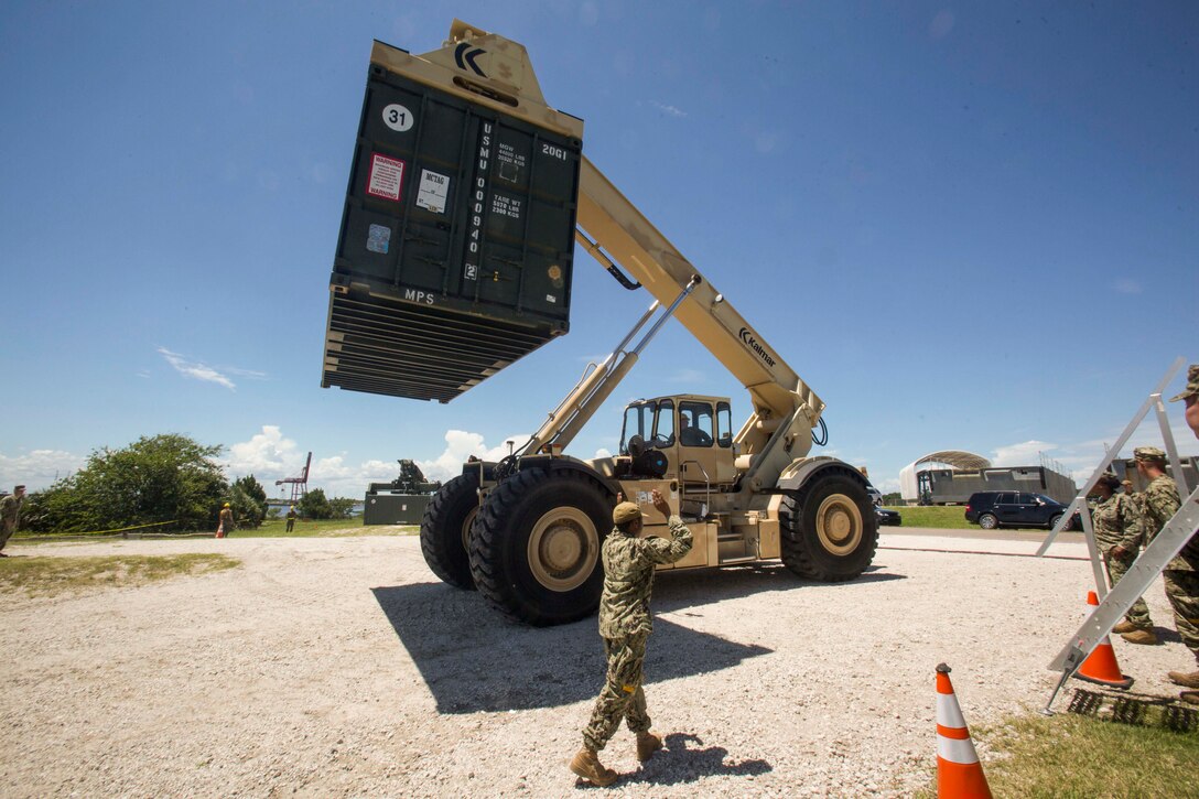 Sailors aboard a naval landing craft prepare to land and perform a lighterage during a marine prepositioning force exercise at Blount Island, Fla., Aug. 10 - 11, 2017.