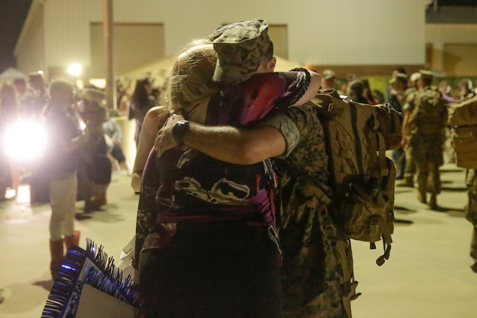 A Marine hugs a family member after coming from a deployment, at Camp Lejeune, N.C., August 12, 2017. Marines and Sailors returned from a 6-month Unit Deployment Program in Okinawa, Japan. V38 conducted exercises in Okinawa, Mainland Japan, South Korea, Thailand, the Philippines, Guam and other smaller islands. (U.S. Marine Corps photo by Lance Cpl. Leynard Kyle Plazo)