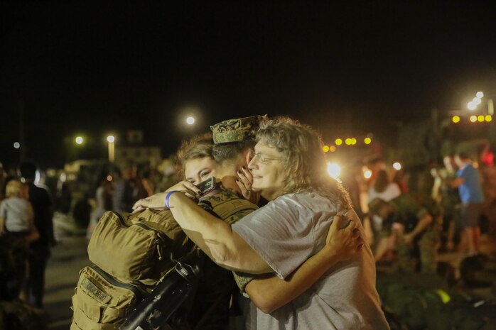 A Marine reunites with his family after returning from a deployment, at Camp Lejeune, N.C., August 12, 2017. Marines and Sailors returned from a 6-month Unit Deployment Program in Okinawa, Japan. V38 conducted exercises in Okinawa, Mainland Japan, South Korea, Thailand, the Philippines, Guam and other smaller islands. (U.S. Marine Corps photo by Lance Cpl. Leynard Kyle Plazo)