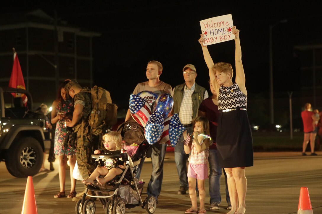 A Marine reunites with his family after returning from a deployment, at Camp Lejeune, N.C., August 12, 2017. Marines and Sailors returned from a 6-month Unit Deployment Program in Okinawa, Japan. V38 conducted exercises in Okinawa, Mainland Japan, South Korea, Thailand, the Philippines, Guam and other smaller islands. (U.S. Marine Corps photo by Lance Cpl. Leynard Kyle Plazo)