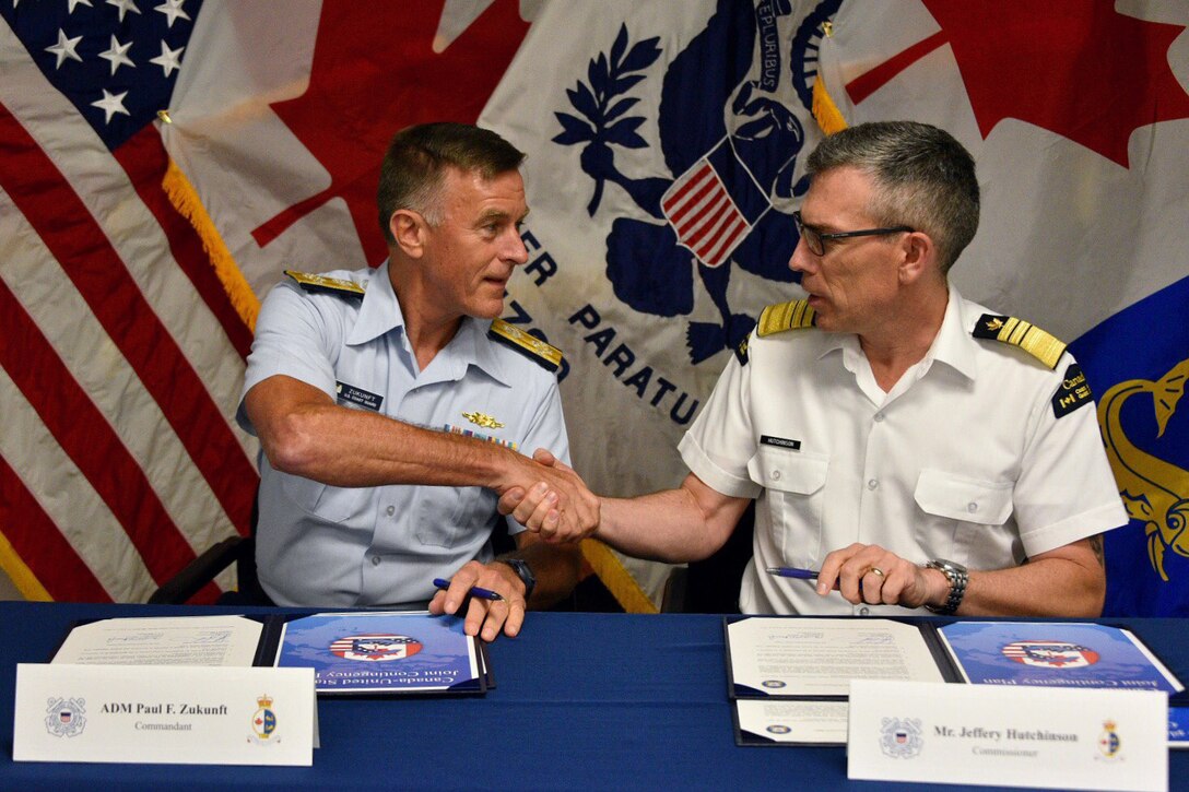 Photo of U.S. Coast Guard Commandant and Canadian Coast Guard commissioner at the signing of the Canada, U.S. Joint Contingency Plan, Aug. 3, 2017