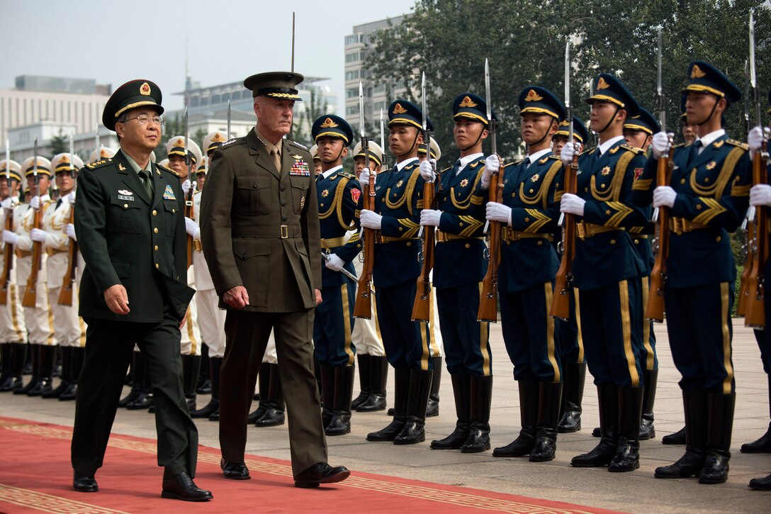 Military leaders inspect Chinese troops in Beijing.