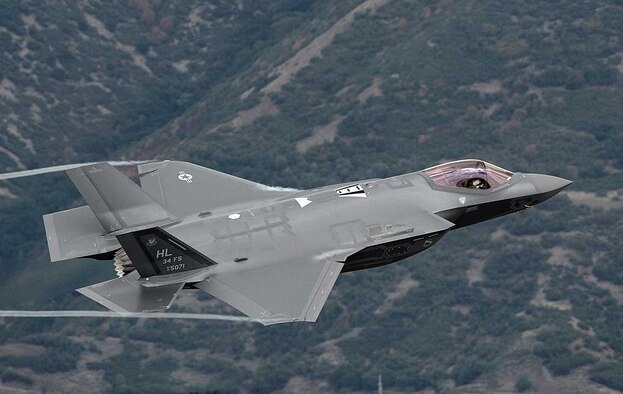 Lt. Col. George Watkins, the 34th Fighter Squadron commander, flies his combat-coded F-35A Lightning II aircraft past the control tower on Sept. 17, 2015, at Hill Air Force Base, Utah. During the sortie Watkins conducted mission qualification training focusing on weapons employment, range familiarization and mission system proficiency. (U.S. Air Force photo/Alex R. Loyd)