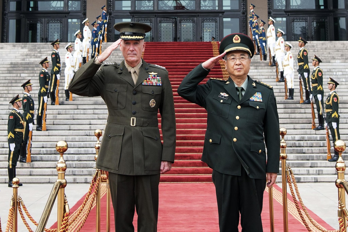 Marine Corps Gen. Joe Dunford stands next to Chinese Army Gen. Fang Fenghui as both leaders salute.