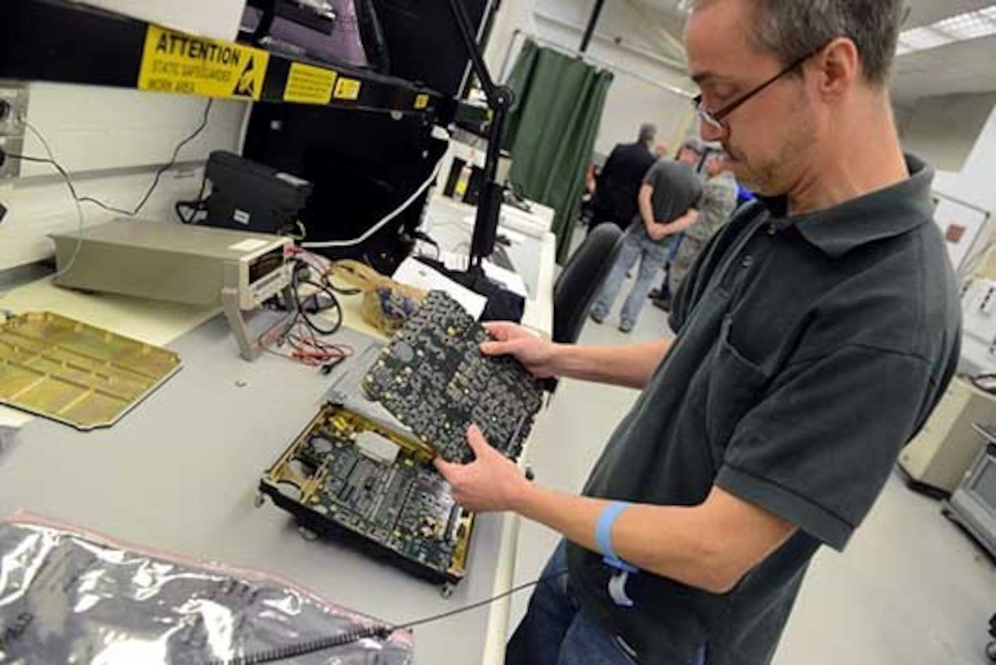 Michael Bailey, an electronics technician with the 568th Electronics Maintenance Squadron at Robins Air Force Base, Ga., removes a faulty circuit card assembly from a Remote Input/Output unit, which is part of the F-35’s communication system. Team members from the 402nd Electronics Maintenance Group contributed vital support in the Marine Corps F-35B Lightning II aircraft’s declaration of Initial Operational Capability on July 31, 2015. The Air Force reached IOC with the F-35A variant in 2016, with the Navy’s F-35 IOC set for 2018-2019. (U.S. Air Force photo by Tommie Horton)