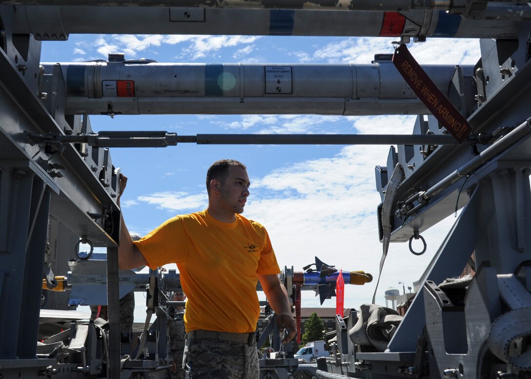 U.S. Air Force Airman 1st Class Luis Vega, 27th Aircraft Maintenance Unit load crew member, inspects munitions during the 1st Maintenance Squadron Weapons Load Crew of the Quarter competition at Joint Base Langley-Eustis, Va., Aug. 4, 2017.