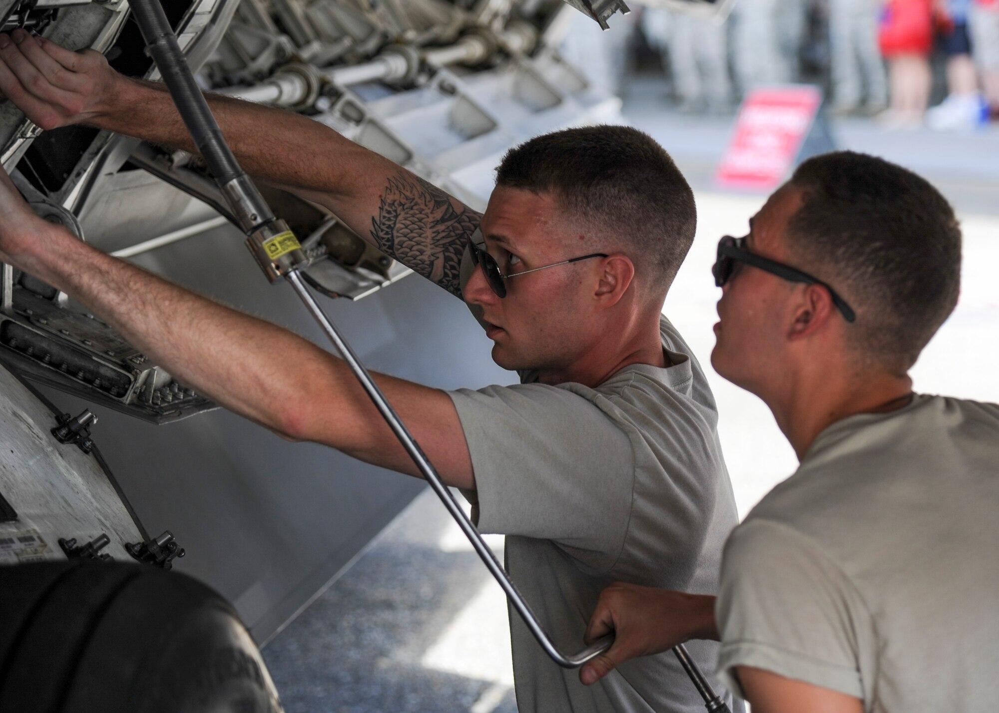 (From left) U.S. Air Force Staff Sgt. Justin Smith, 94th Aircraft Maintenance Unit load crew chief, and Airman 1st Class Samuel Gulbranson, 94th AMU load crew member, prepare to load munitions during the 1st Maintenance Squadron Weapons Load Crew of the Quarter competition at Joint Base Langley-Eustis, Va., Aug. 4, 2017.