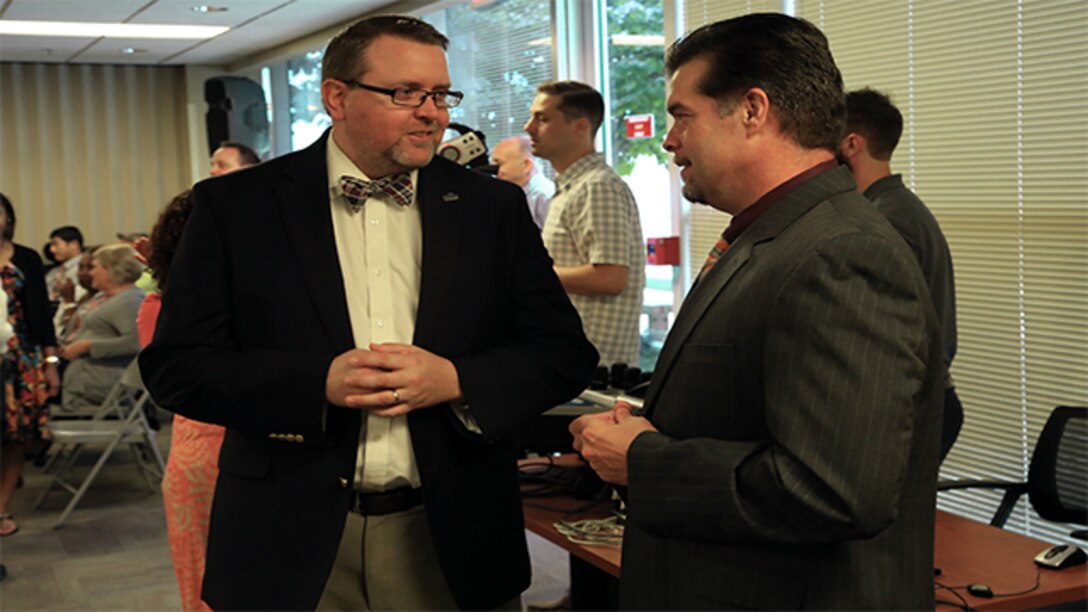 Defense Contract Management Agency Chief of Public Affairs, Mark Woodbury, and Collaboration Portfolio Manager, Joe Rhodes, collaborate communication efforts during the global all hands July 26, 2017 at Fort Lee, Virginia. (DCMA photo by Elizabeth Szoke)