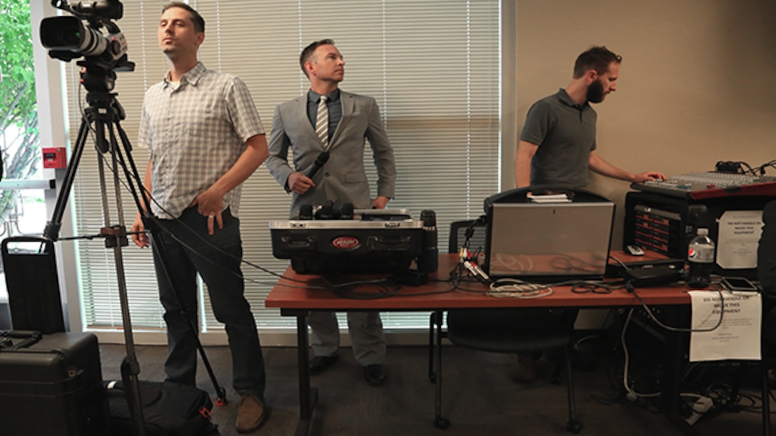 Defense Contract Management media services specialists, Mike Dunbar, Joel Martinson and Michael Street monitor audio and video feeds being distributed to the workforce from Fort Lee, Virginia, July 26, 2017. (DCMA photo by Elizabeth Szoke)