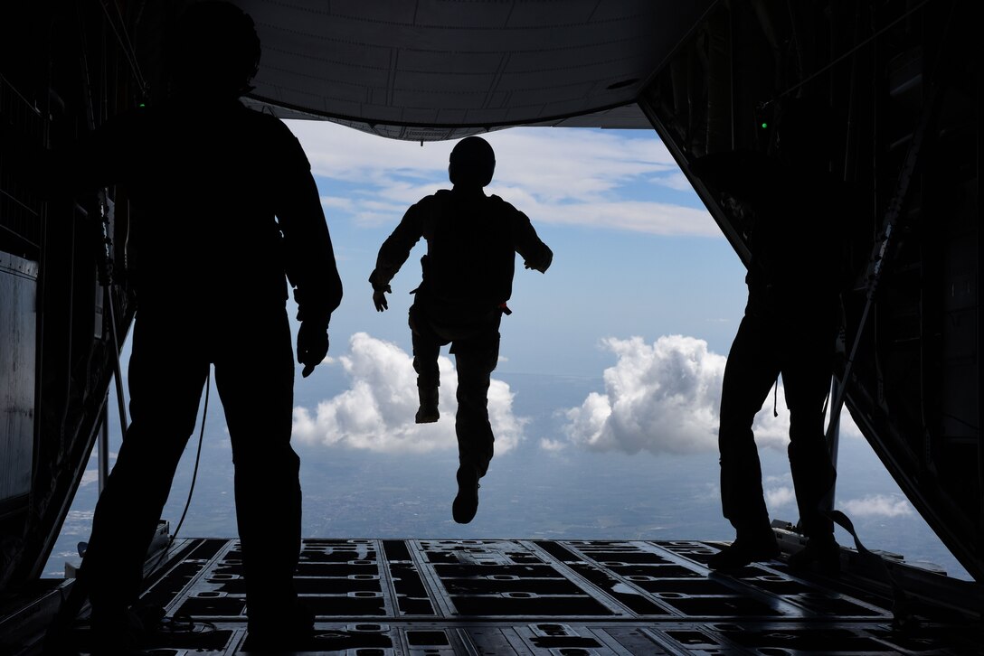 An airman assigned to the 57th Rescue Squadron begins a free fall jump.