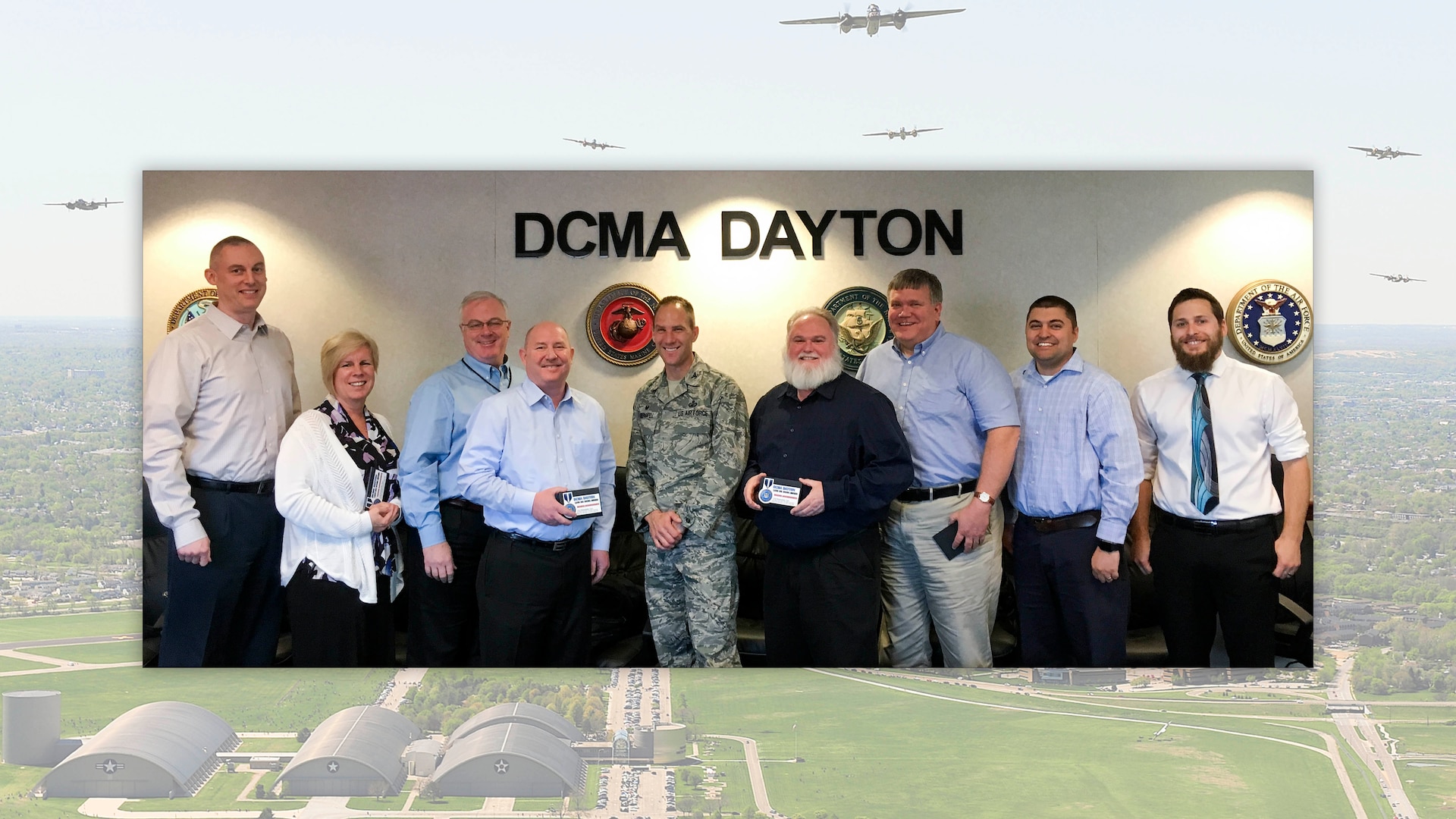 Air Force Col. Eric Obergfell (center), instructed his extended team of contracting professionals at Defense Contract Management Agency Dayton, Indianapolis and Cleveland that Continuous Process Improvement was a priority more than 24 months ago. Team members have embraced the initiative and success has followed. (DCMA graphic by Thomas Perry)