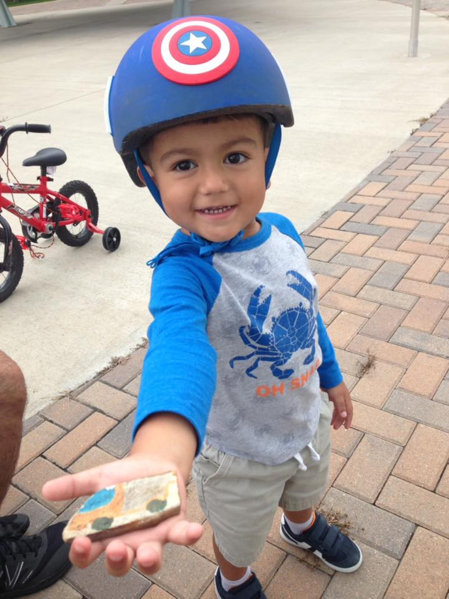 Evan Cosentino shows off the rock he found on Peterson Air Force Base, Colo., Aug. 5. 2017. The hidden rocks provide kids with a little excitement and the opportunity to get outside. (Courtesy photo by Charlotte Cosentino)
