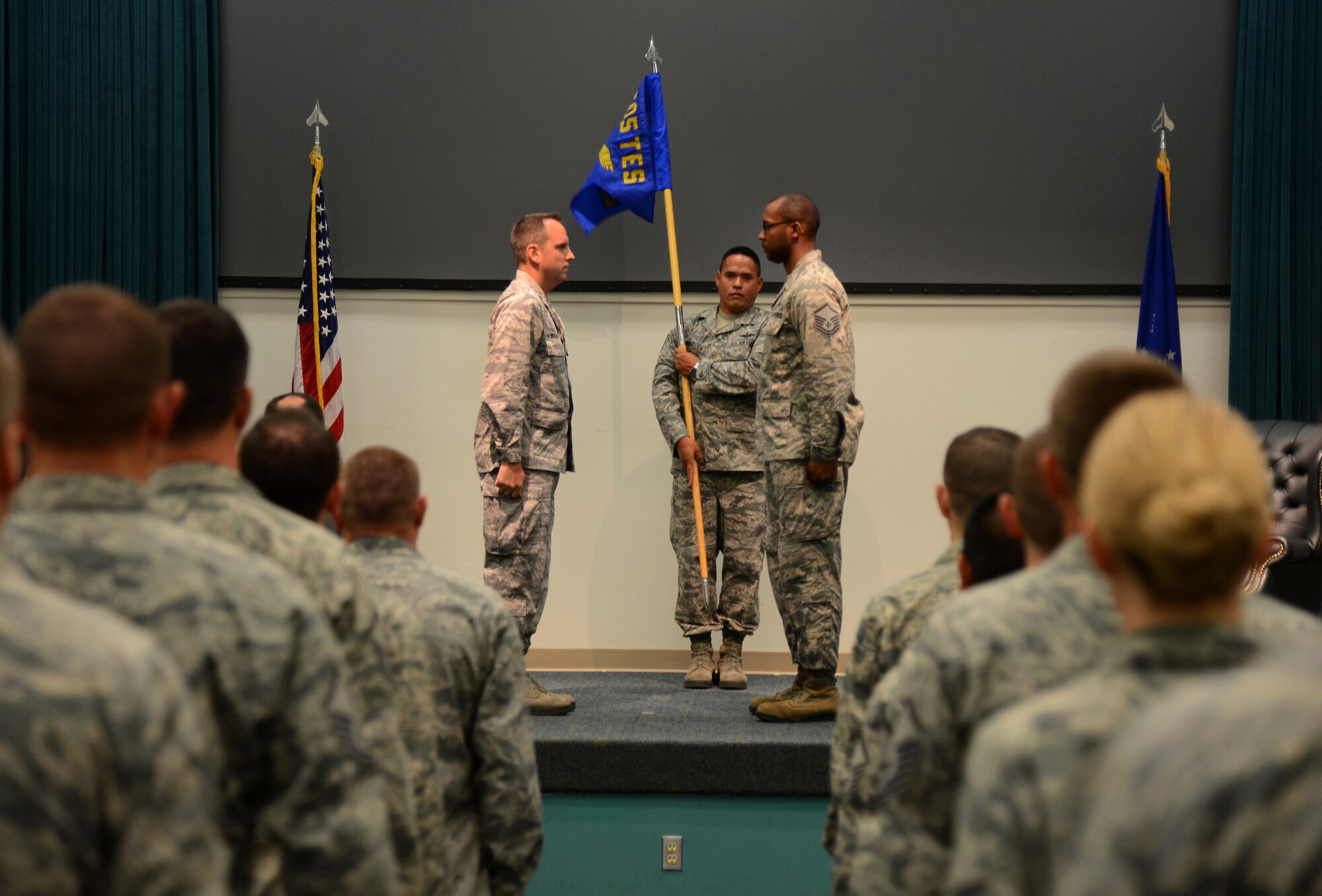 The guidon for the 605th Test and Evaluation Squadron, Detachment 1, is officially unfurled during a Flag Uncasing Ceremony in Fannin Hall Aug. 7.