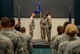 The guidon for the 605th Test and Evaluation Squadron, Detachment 1, is officially unfurled during a Flag Uncasing Ceremony in Fannin Hall Aug. 7, 2017. From left, 605th Director of Operations Lt. Col. Tyler Wickham, guidon bearer Tech. Sgt. Kamanu Fernandez and Master Sgt. Trevelle Harris perform the unfurling in front of their squadron members and guests. (Air Force photo by Kelly White)