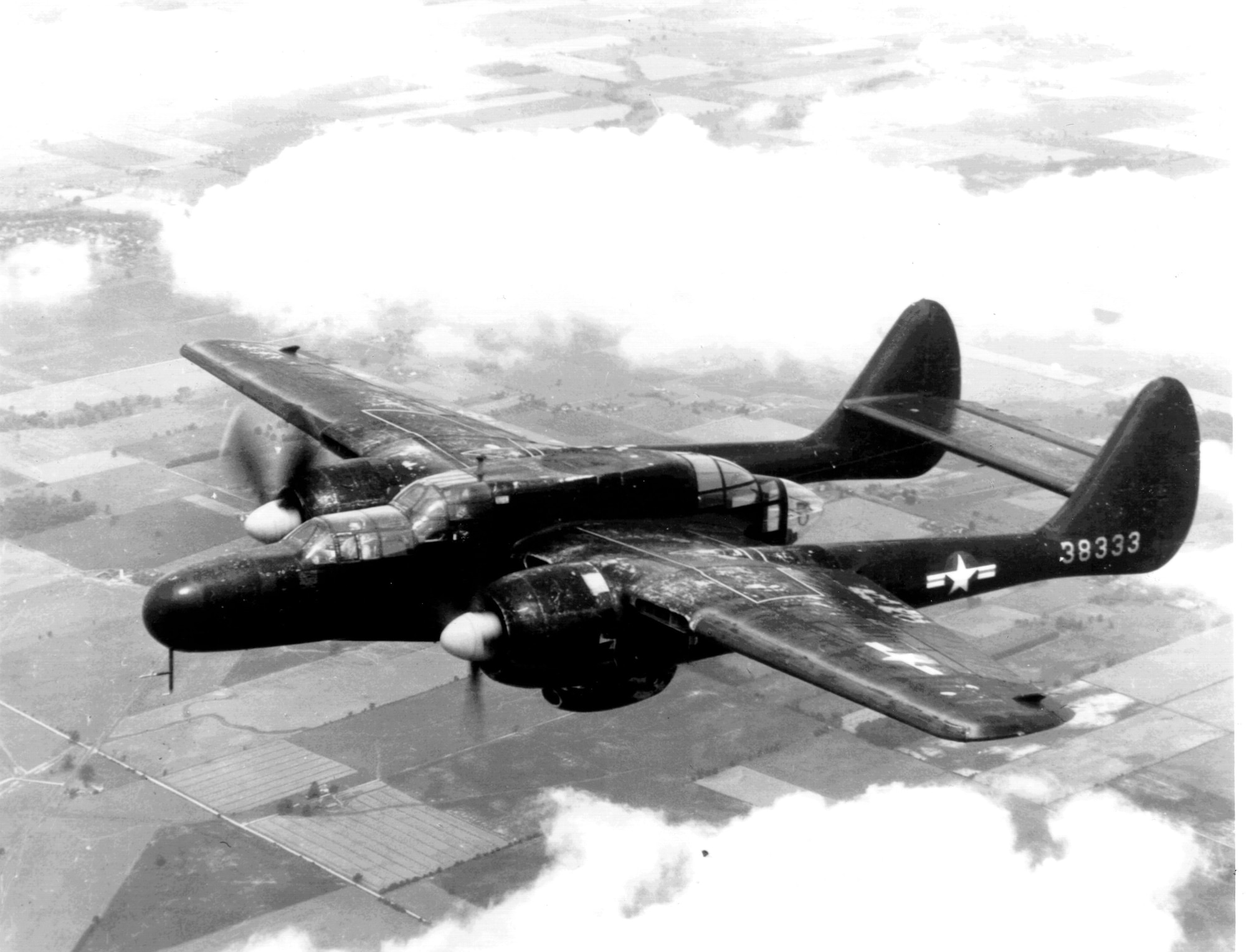 An all-black P-61A Black Widow captured in-flight shows the design features of the aircraft type during service with the Army Air Corps.