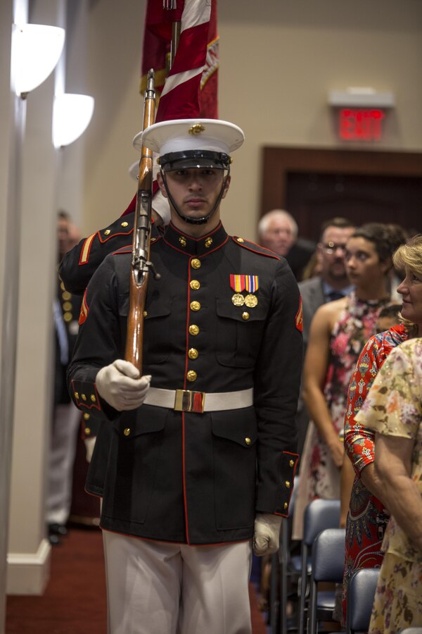 The U.S. Marine Corps Color Guard marches with the National Ensign and the U.S. Marine Corps Colors during an indoor ceremony at Marine Barracks Washington D.C., Aug. 11, 2017. The guest of honor for the parade was Secretary of Agriculture, the Honorable Sonny Perdue, and the hosting official was the Assistant Commandant of the United States Marine Corps, Gen. Glenn M. Walters. (Official Marine Corps photo by Lance Cpl. Damon Mclean/Released)