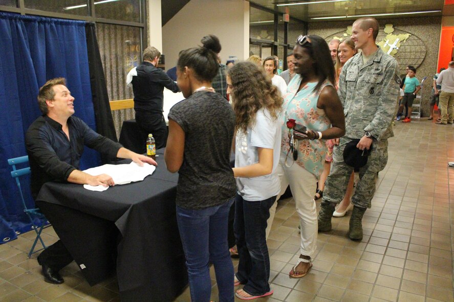 Mike Super, a nationally recognized magician and illusionist, signs his autograph on shirts and posters