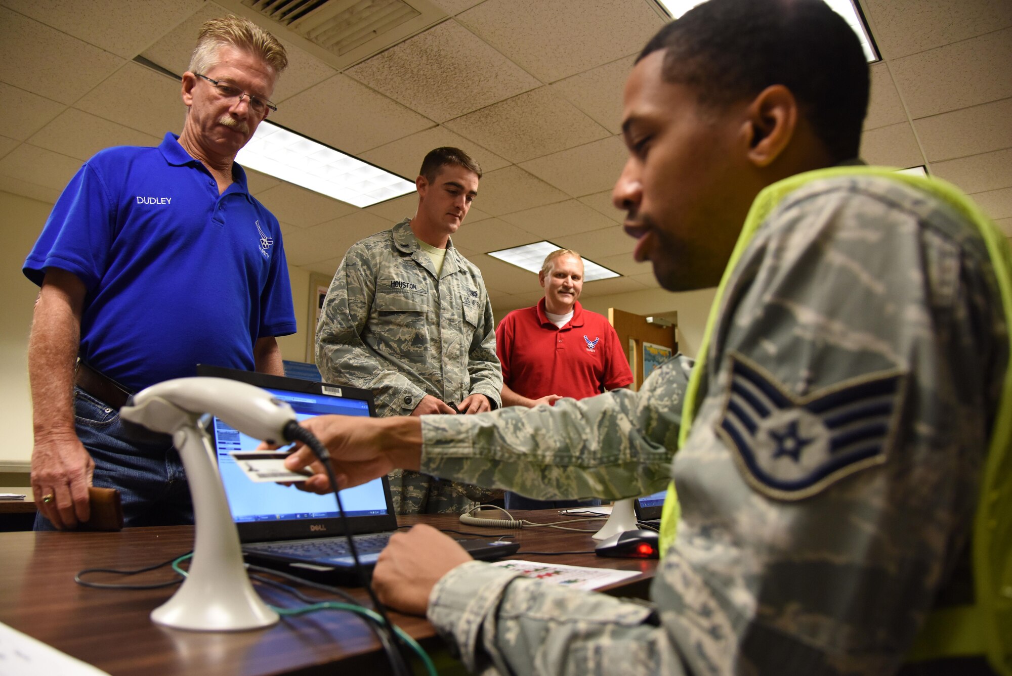 Staff Sgt. Brandon Brown, 335th Training Squadron instructor and shelter management team member, in-processes Dudley Cruse, 81st Training Wing safety technician, into Wolfe Hall for sheltering during a hurricane exercise Aug. 11, 2017, on Keesler Air Force Base, Miss. Each year Keesler personnel participate in exercise scenarios like this to ensure they can respond to hurricane threats. (U.S. Air Force photo by Kemberly Groue)