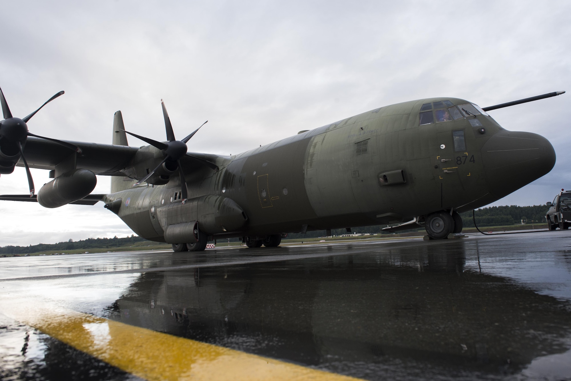 A British Royal Air Force 47th Squadron C-130 Hercules is reflected by the rain-soaked flightline at Joint Base Elmendorf-Richardson, Alaska, Aug. 11, 2017. The RAF airmen are at JBER for training exercise Red Flag Alaska-17-3.