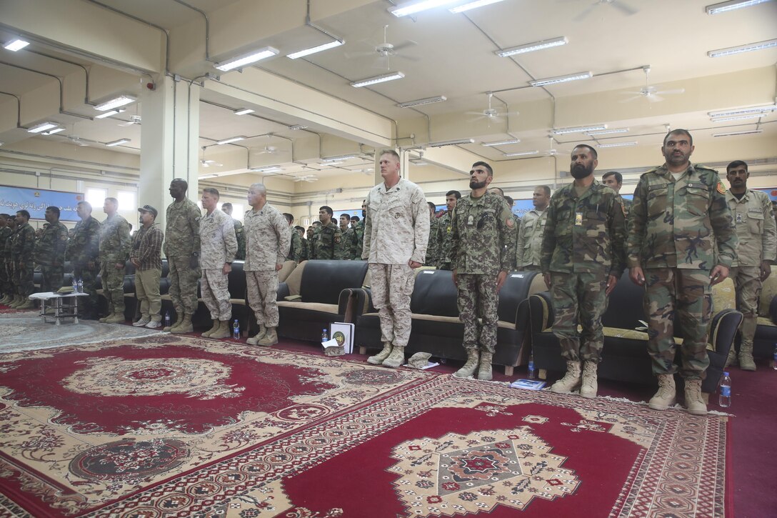 U.S. service members with various units and Afghan National Army noncommissioned officers assigned to 215th Corps stand during the playing of the Afghan National Anthem at Camp Shorabak, Afghanistan, Aug. 13, 2017. More than 100 NCOs completed a professional military education seminar Aug. 12-14. Throughout the training, senior enlisted leaders from the ANA stressed the importance of leadership, mentoring young soldiers and technical and tactical proficiency in combat. (U.S. Marine Corps photo by Sgt. Lucas Hopkins)