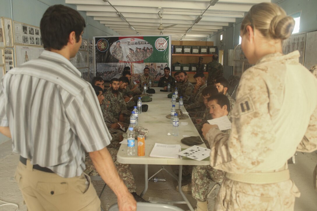 U.S. Navy Sailor Lt. Laura Cargill, right, the lead medical planner of Task Force Southwest, instructs Afghan National Army soldiers with 2nd Kandak, 4th Brigade, 215th Corps how to properly call for a casualty evacuation at Camp Shorabak, Afghanistan, Aug. 13, 2017. Several ANA units partnered with the Afghan Air Force and U.S. advisors to enhance their CASEVAC procedures through classroom instruction and practical application. Quickening the CASEVAC process allows for faster movement of a wounded soldier to a medical facility and greatly improves chances for survivability and full recovery. (U.S. Marine Corps photo by Sgt. Lucas Hopkins)