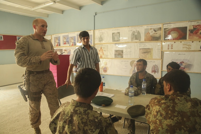 U.S. Marine Capt. Robert Walters, left, an air advisor with Task Force Southwest, instructs Afghan National Army soldiers with 2nd Kandak, 4th Brigade, 215th Corps proper casualty evacuation reporting procedures at Camp Shorabak, Afghanistan, Aug. 13, 2017. Several U.S. advisors worked with more than 30 ANA soldiers and elements of the Afghan Air Force to improve their CASEVAC process, which will vastly increase the survivability and recovery rates of wounded personnel on the battlefield. (U.S. Marine Corps photo by Sgt. Lucas Hopkins)