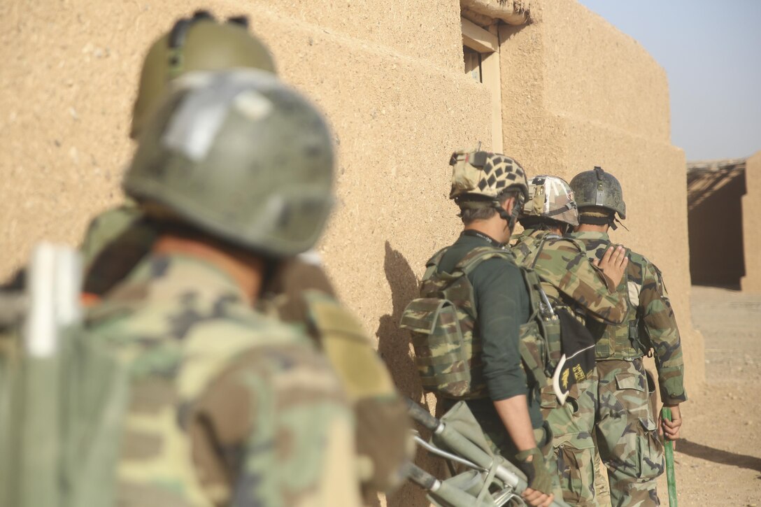 Afghan National Army soldiers with 215th Corps prepare to clear a simulated enemy compound during casualty evacuation training at Camp Shorabak, Afghanistan, Aug. 14, 2017. More than 30 ANA soldiers partnered with the Afghan Air Force and U.S. advisors, extracting notionally-wounded personnel via helicopter in preparation for future operations. Faster CASEVACS allow for quick and safe transportation of injured soldiers to medical facilities, greatly improving their chances of survival and recovery. (U.S. Marine Corps photo by Sgt. Lucas Hopkins)