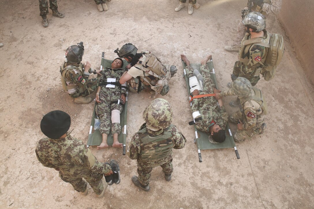 Afghan National Army soldiers with 215th Corps prepare to carry notionally-wounded personnel onto an Afghan Air Force Mi-17 Helicopter during casualty evacuation training at Camp Shorabak, Afghanistan, Aug. 14, 2017. Several ANA units rehearsed and refined their CASEVAC process and quickened response times, helping to improve chances of survivability and recovery for injured service members. (U.S. Marine Corps photo by Sgt. Lucas Hopkins)