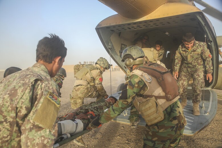 Afghan National Army soldiers with 215th Corps load a simulated casualty onto an Afghan Air Force Mi-17 Helicopter during casualty evacuation training at Camp Shorabak, Afghanistan, Aug. 14, 2017. More than 30 ANA soldiers with various units worked to refine their CASEVAC procedures in preparation for real-world operations. Quickening response time and providing proper medical care before extraction vastly increases the chances of survivability and recovery for wounded personnel. (U.S. Marine Corps photo by Sgt. Lucas Hopkins)