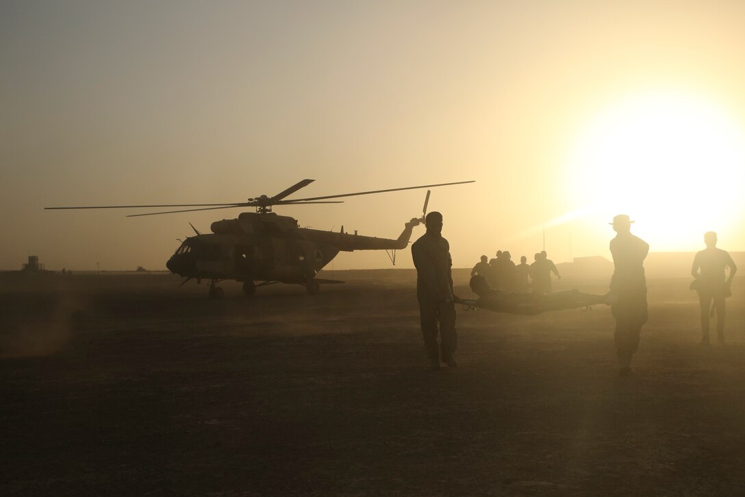 Afghan National Army soldiers extract a notional casualty from an Afghan Air Force Mi-17 Helicopter during casualty evacuation training at Camp Shorabak, Afghanistan, Aug. 14, 2017. Several ANA units partnered with the Afghan Air Force and U.S. advisors to enhance their CASEVAC procedures through classroom instruction and practical application. Quickening the CASEVAC process allows for faster movement of a wounded soldier to a medical facility and greatly improves chances for survivability and full recovery. (U.S. Marine Corps photo by Sgt. Lucas Hopkins)