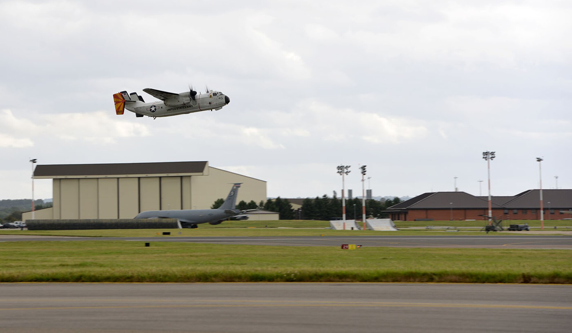 A U.S. Navy C-2A Greyhound takes off from the airfield on RAF Mildenhall, England, as it heads out as part of Exercise Saxon Warrior Aug. 3, 2017. Two C-2A aircraft were TDY to RAF Mildenhall as part of Exercise Saxon Warrior, a multinational joint maritime exercise involving 15 warships from five different nations, along with submarines, more than 100 aircraft and approximately 9,000 personnel. (U.S. Air Force photo by Karen Abeyasekere)