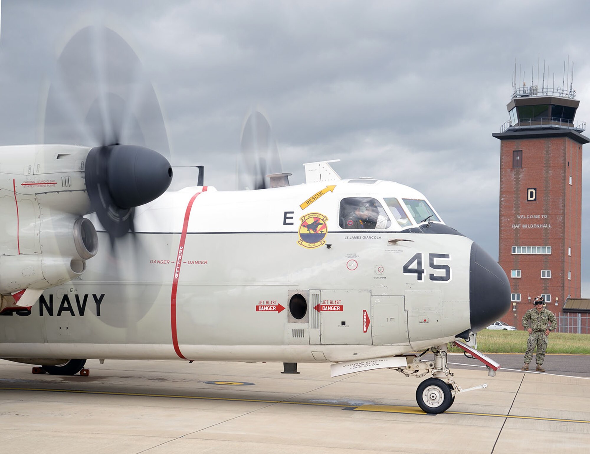 A U.S. Navy C-2A Greyhound prepares to taxi along the flightline near the aircraft control tower on RAF Mildenhall, England, as it heads out on a mission to the USS George H.W. Bush aircraft carrier (CVN77) Aug. 3, 2017. Two C-2A aircraft were TDY to RAF Mildenhall as part of Exercise Saxon Warrior, a multinational joint maritime exercise involving 15 warships from five different nations, along with submarines, more than 100 aircraft and approximately 9,000 personnel. (U.S. Air Force photo by Karen Abeyasekere)