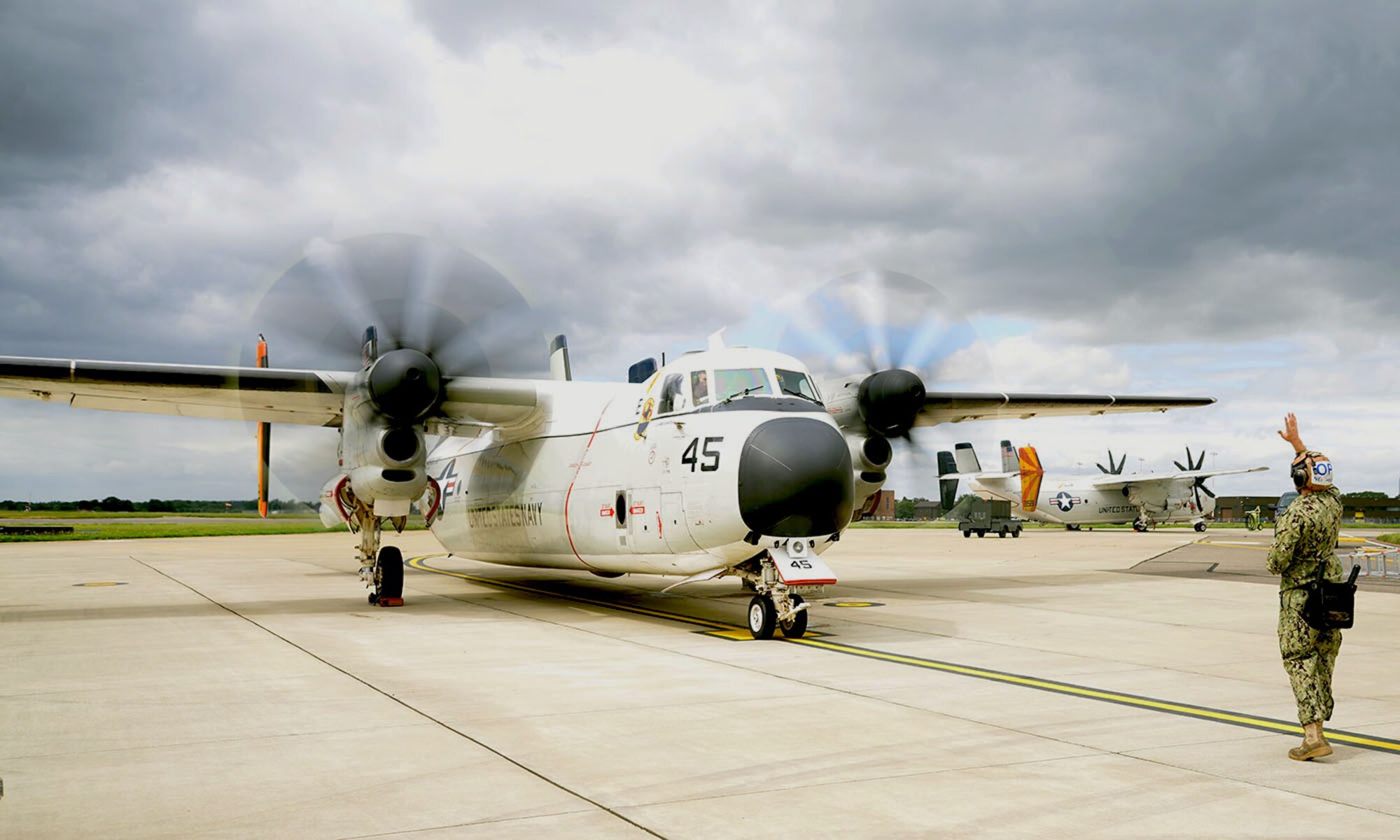 A U.S. Navy C-2A Greyhound performs last-minute checks as it prepares to fly out to the USS George H.W. Bush (CVN77) aircraft carrier Aug. 3, 2017, on RAF Mildenhall, England. Two C2-A aircraft were TDY to RAF Mildenhall as part of Exercise Saxon Warrior, a multinational joint maritime exercise involving 15 warships from five different nations, along with submarines, more than 100 aircraft and approximately 9,000 personnel. (U.S. Air Force photo by Karen Abeyasekere)