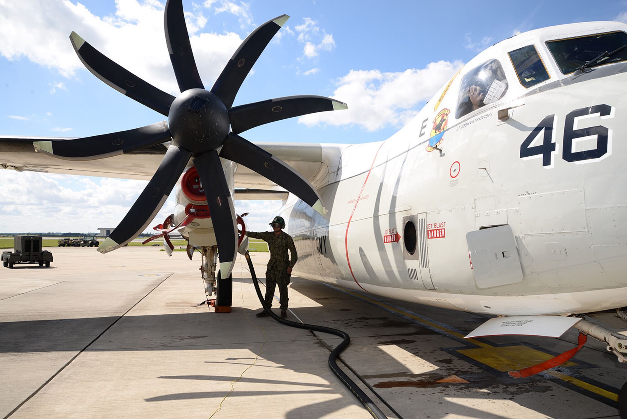 U.S. Navy PR3 Kyle Coger, VRC-40 aircrew survival equipmentman, holds a refueling hose in place on a C-2A Greyhound as it is refueled by a U.S. Air Force Airman from the 100th Logistics Readiness Squadron Aug. 2, 2017, on RAF Mildenhall, England. Members of the U.S. Navy, VRC-40, from Norfolk, Va., were here as part of Exercise Saxon Warrior. The Greyhounds cannot be refueled in the air so they were refueled by truck while on the ground. (U.S. Air Force photo by Karen Abeyasekere)