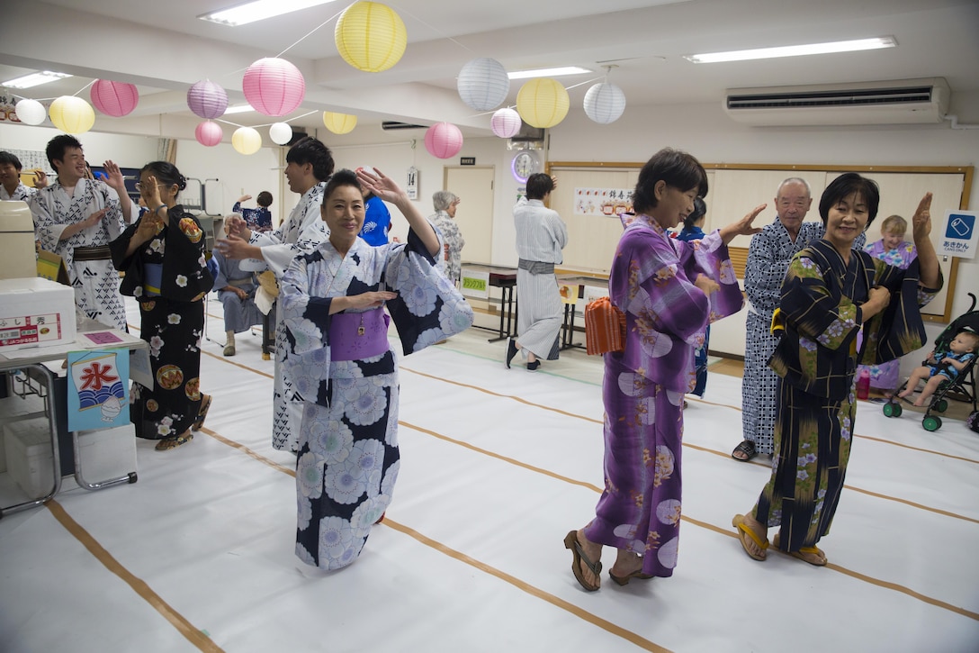 Japanese locals perform the Bon-Odori, or Bon dance, during the Bon-Odori festival at Kinjuen nursing home in Iwakuni, Japan, Aug. 14, 2017.