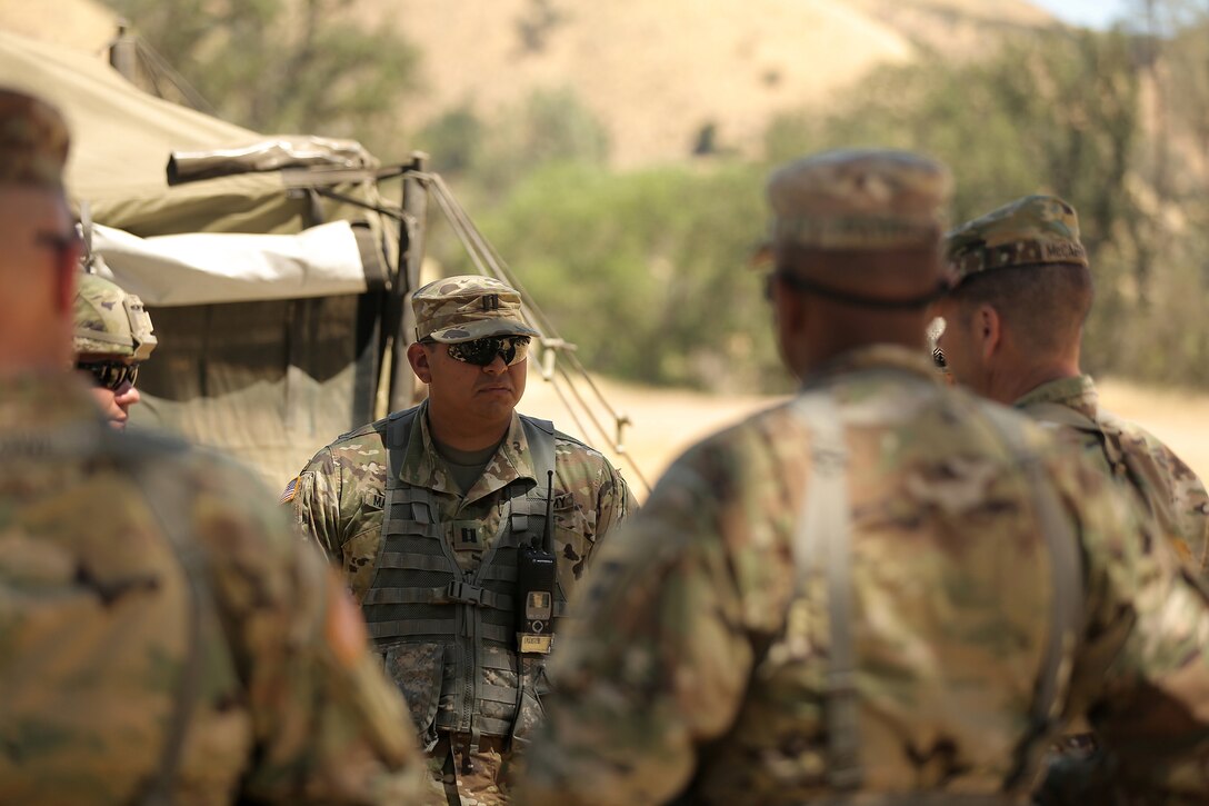 Army Capt. Gustavo Madrigal briefs Maj. Gen. Todd McCaffrey