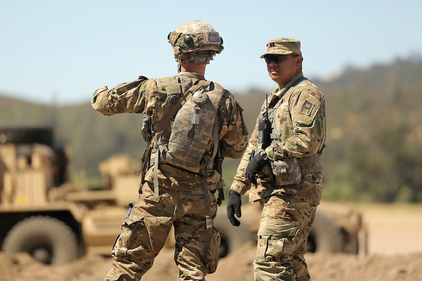 Army Capt. Gustavo Madrigal works with a Army Reservist