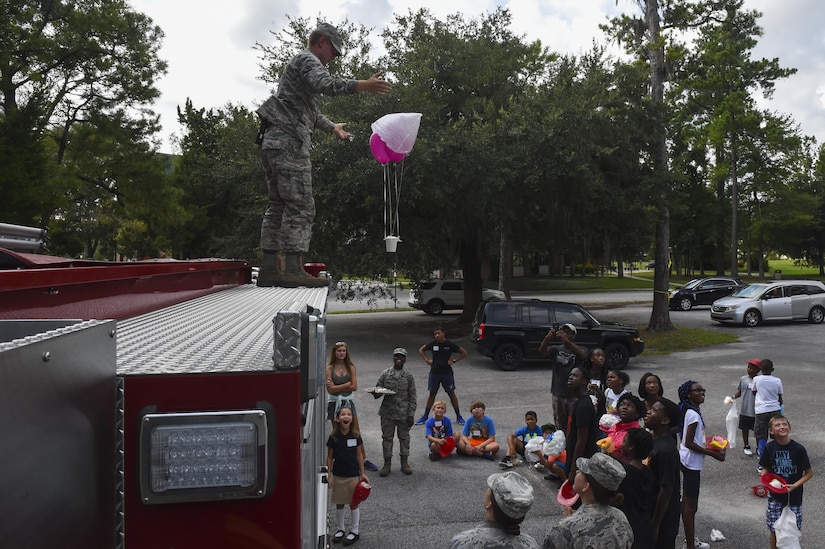 Airman Joseph Wright, 628th Civil Engineer Squadron firefighter, tests out an egg parachute created during STEM Day, a science, technology, engineering and mathematics event for children from ages 10 to 18 years old, at the Air Base Chapel Annex on Joint Base Charleston, S.C., Aug. 14.