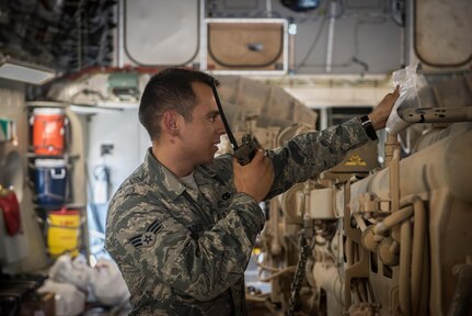 Senior Airman David Tiradeau, a ramp coordinator assigned to the 386th Expeditionary Logistics Readiness Squadron, relays information to the air terminal operations center, at an undisclosed location in Southwest Asia, August 15, 2017.