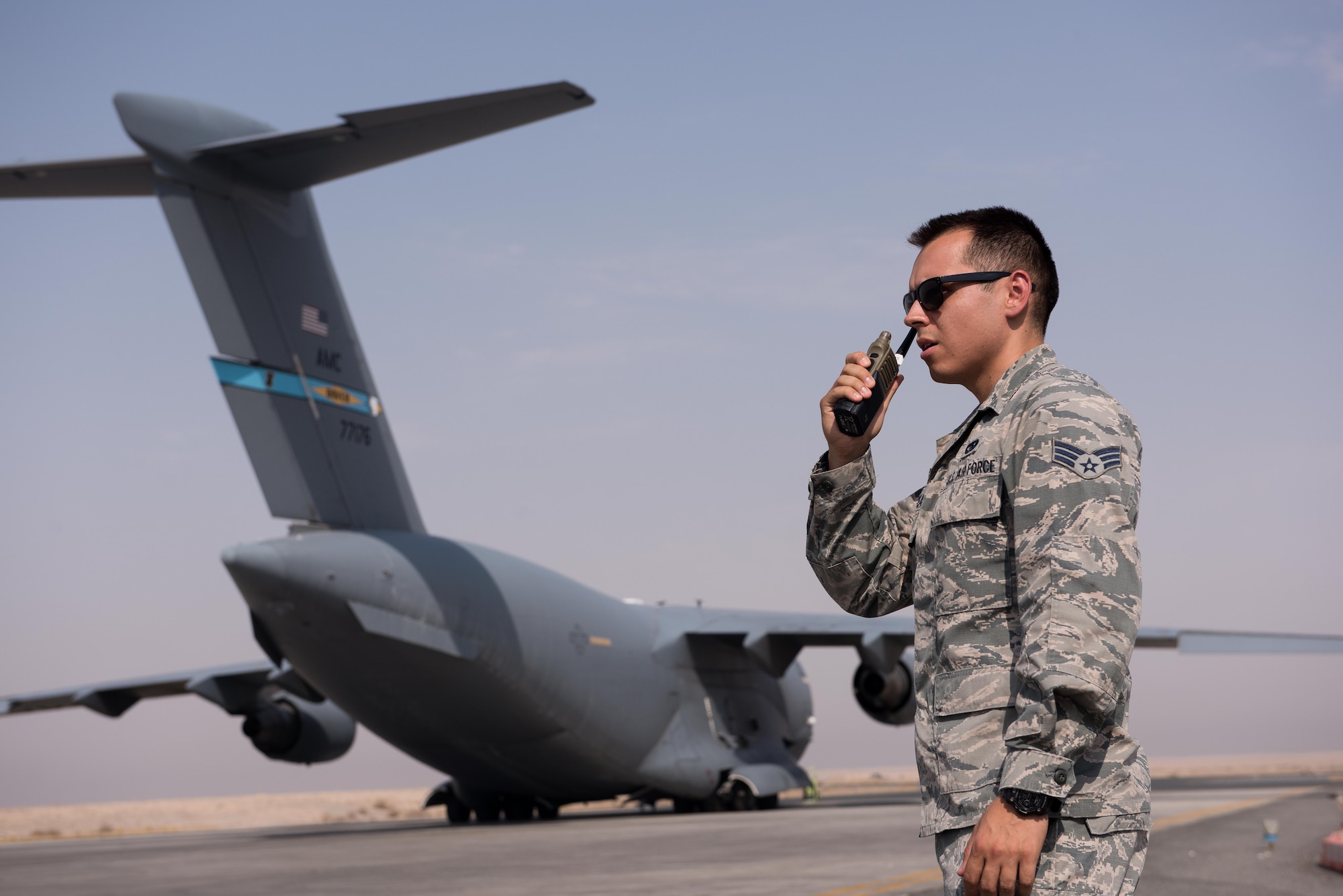 Senior Airman David Tiradeau, a ramp coordinator assigned to the 386th Expeditionary Logistics Readiness Squadron, relays information to the air terminal operations center, at an undisclosed location in Southwest Asia, August 15, 2017.